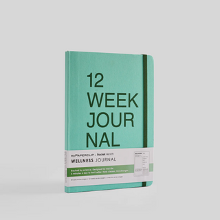 A teal notebook with '12 Week Journal' written on the cover in dark green text. It has rounded corners and an elastic closure.