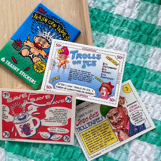 Collection of vintage trading cards on a green and white checkered surface