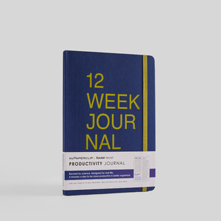 A blue notebook with '12 Week Journal' written on the cover in green text. It has rounded corners and an elastic closure.