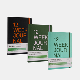 Three books in black, green, and teal with '12 Week Journal' written on the cover. All have rounded corners and an elastic closure.
